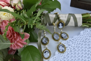 A vintage bouquet with floral accents alongside a ribbon featuring small frames of black-and-white photos.