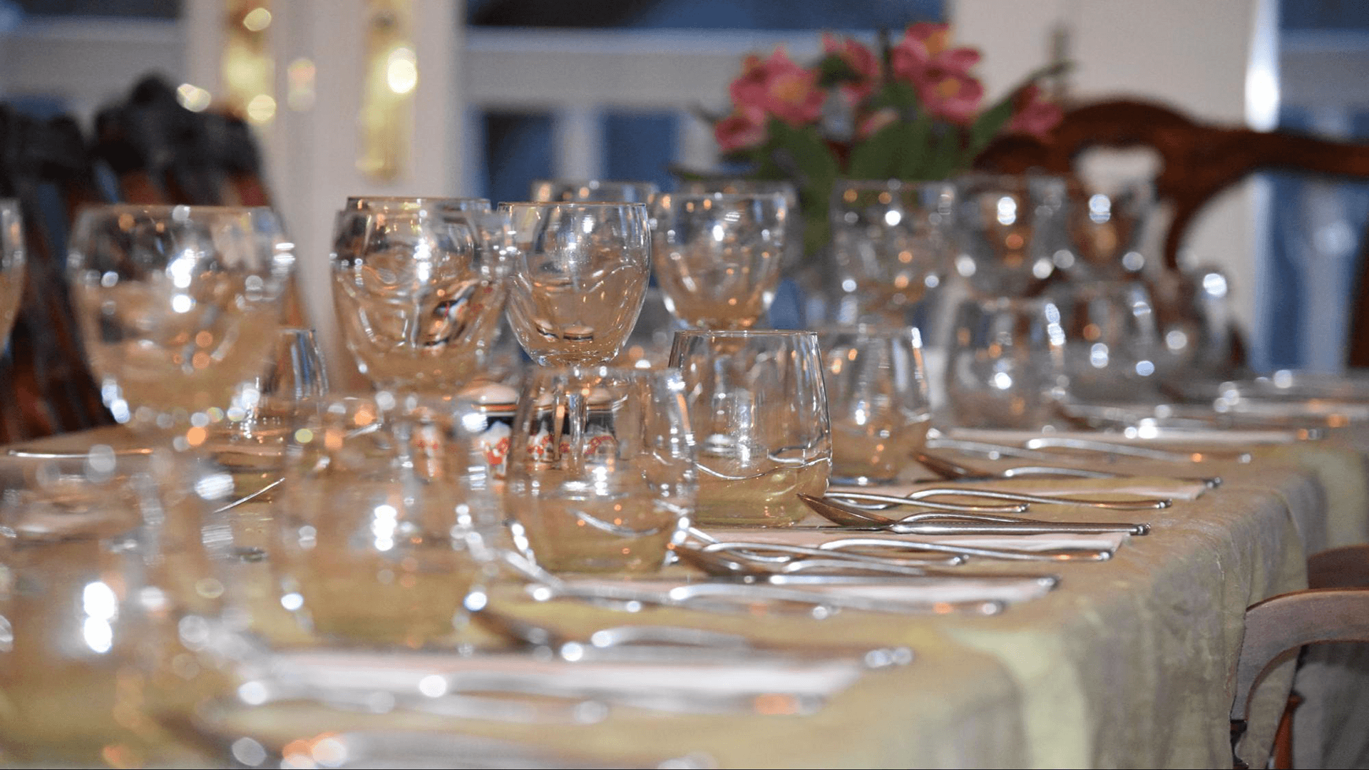 A beautifully set dining table with glassware and silverware arranged elegantly.