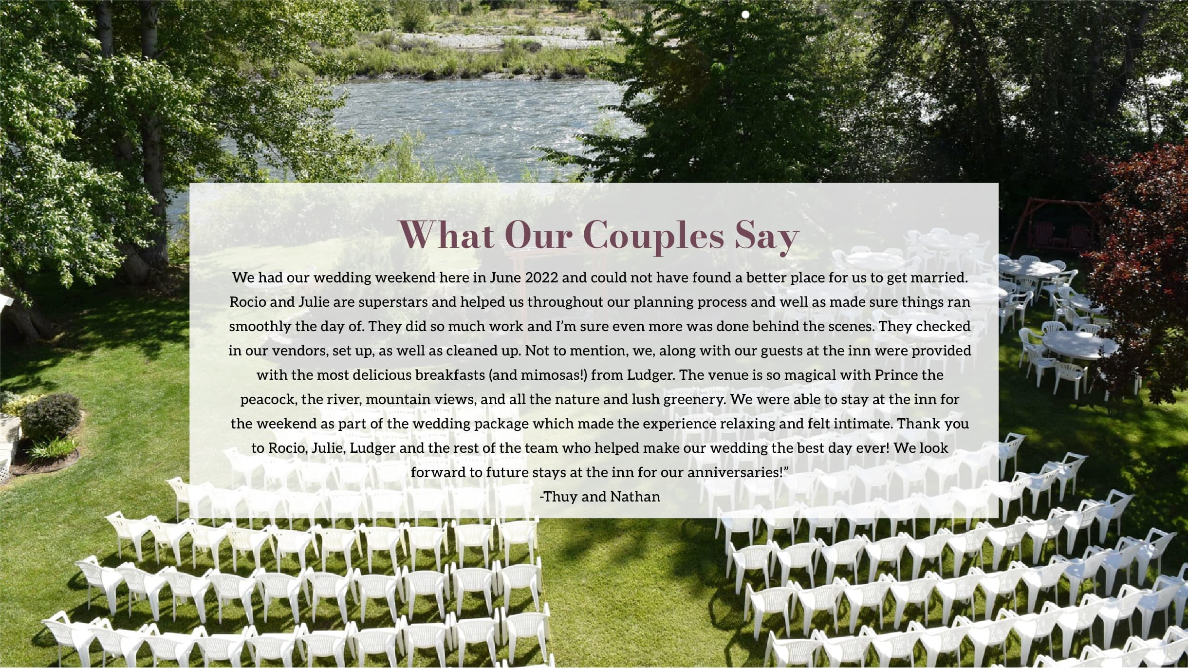 A scenic outdoor wedding venue with white chairs set up beside a river and lush greenery.