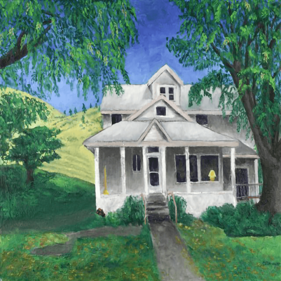 A white house surrounded by greenery and rolling hills under a blue sky.